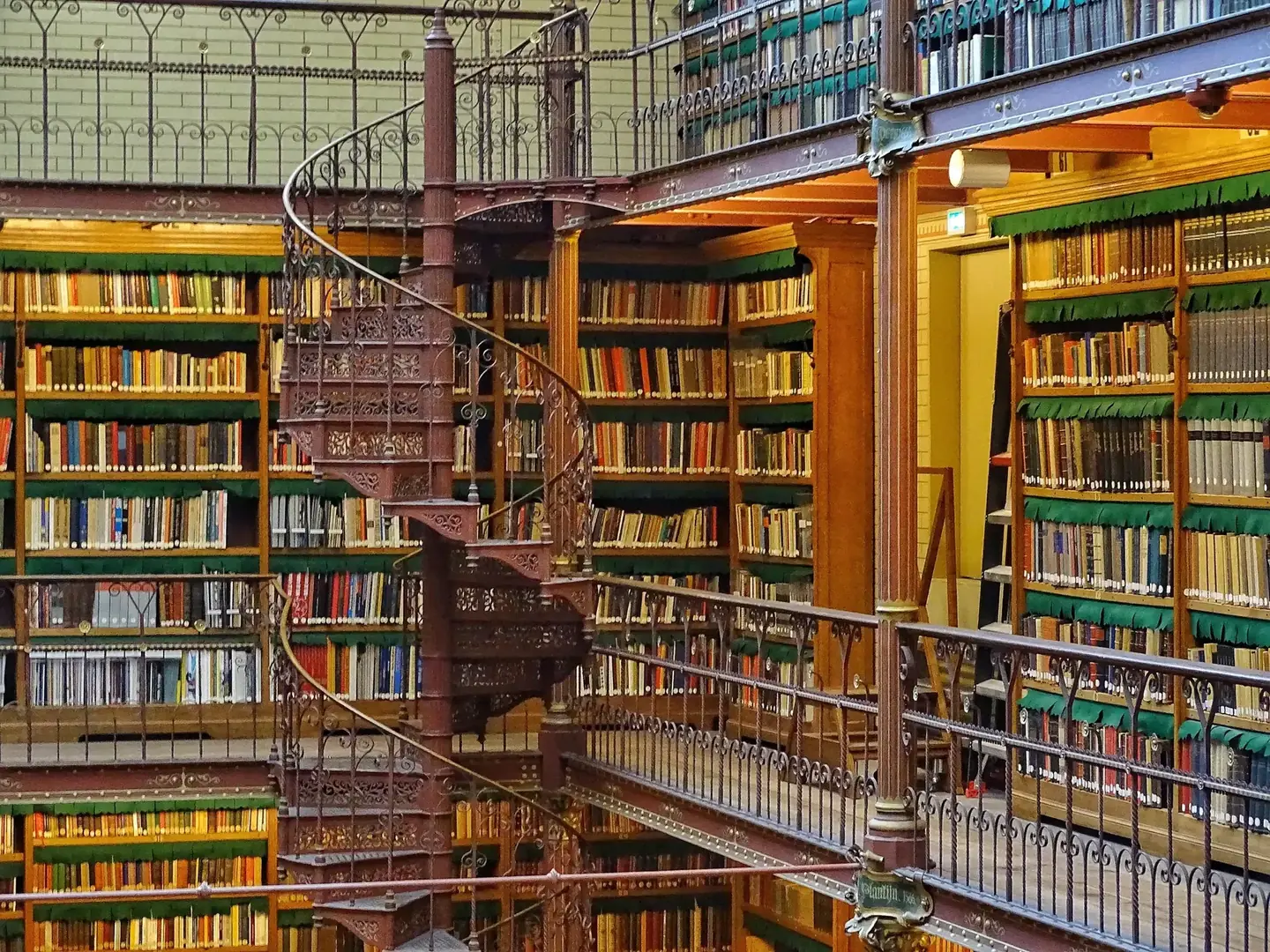 The Rijksmuseum Research Library in Amsterdam: tiered bookshelves, iron galleries and a spiral staircase